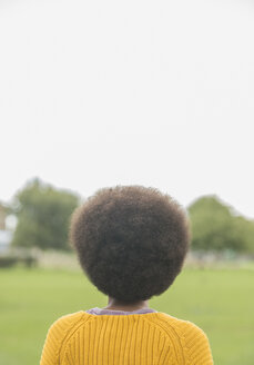 Frau mit Afro im Park stehend - CAIF17660