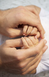 Father holding baby boy's hands - CAIF17759