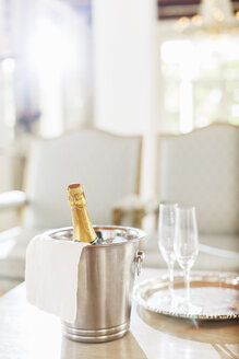 Champagner in einem silbernen Eimer neben Champagnerflöten - CAIF17826