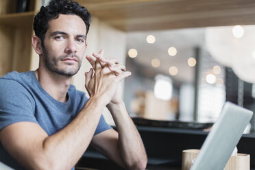 Portrait of confident man at laptop - CAIF17888