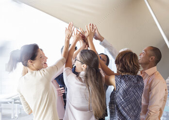 Business people cheering in office - CAIF17916