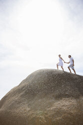 Couple walking on rock formation - CAIF18069