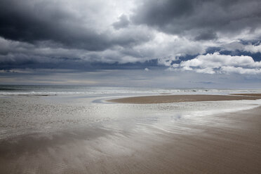 Clouds over beach at low tide - CAIF18076