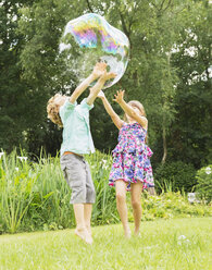 Children playing with bubble outdoors - CAIF18099