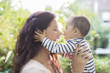 Mother holding baby girl outdoors - CAIF18209