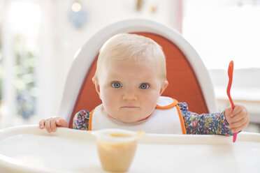 Baby girl eating in high chair - CAIF18230