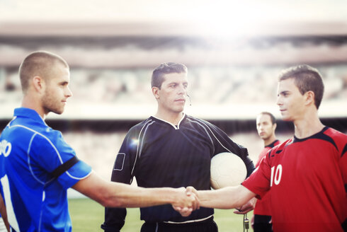 Soccer players shaking hands on field - CAIF18342