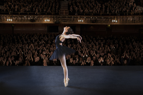 Ballerina performing on stage in theater stock photo