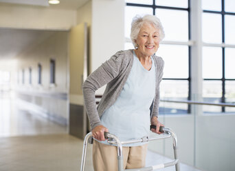 Senior patient using walker in hospital - CAIF18510