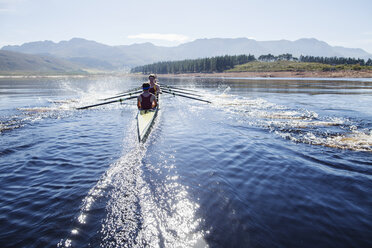 Rowing crew rowing scull on lake - CAIF18628