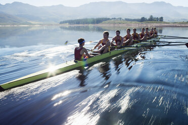 Rowing team rowing scull on lake - CAIF18636