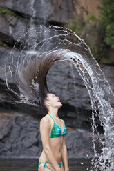 Woman flipping hair in water - CAIF18672