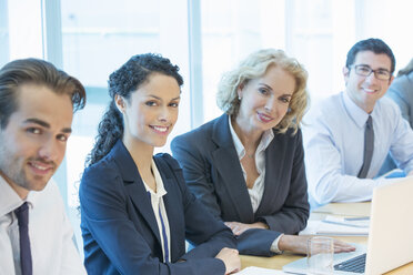 Business people smiling in meeting - CAIF18731