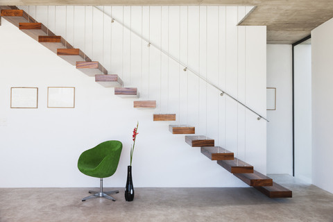 Chair under floating staircase in modern house stock photo