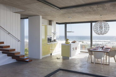 Modern kitchen and dining room overlooking ocean - CAIF18796