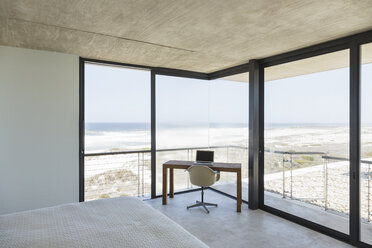 Desk in modern bedroom overlooking ocean - CAIF18821