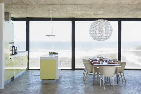 Modern dining room and kitchen overlooking ocean - CAIF18823