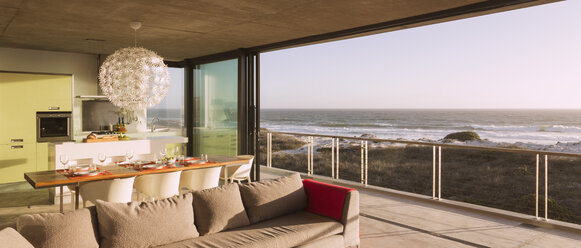 Modern living room and dining room overlooking ocean - CAIF18825