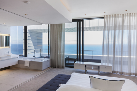Modern bedroom overlooking ocean stock photo