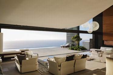 Modern living room overlooking ocean - CAIF19022