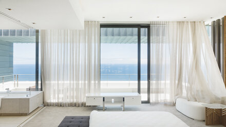 Modern bedroom overlooking ocean - CAIF19031