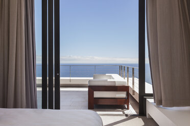 Modern balcony overlooking ocean - CAIF19034