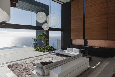 Living room in modern house overlooking ocean - CAIF19039