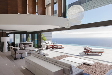 Living room in modern house overlooking ocean - CAIF19041