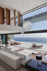 Living room in modern house overlooking ocean - CAIF19042