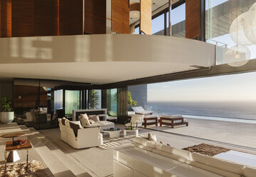Living room in modern house overlooking ocean - CAIF19050