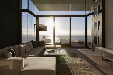 Modern living room overlooking ocean - CAIF19052