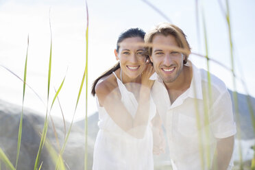 Couple smiling together outdoors - CAIF19141