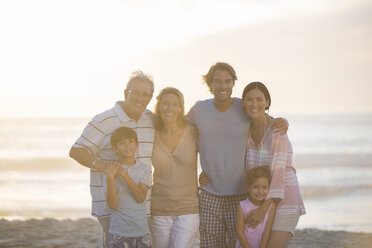 Family smiling together on beach - CAIF19147