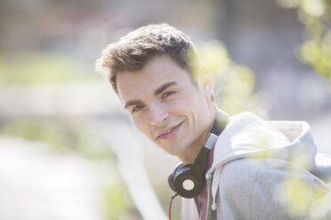 Man wearing headphones outdoors - CAIF19195