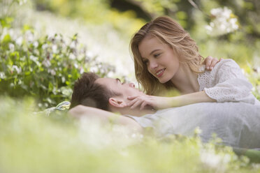 Couple relaxing together in grass - CAIF19201