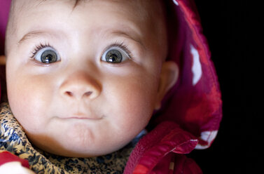 Close up of baby girl's surprised face - CAIF19265