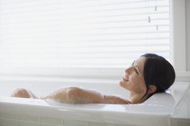 Woman relaxing in bubble bath - CAIF19342