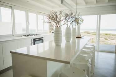 Vases on counter in kitchen with ocean view - CAIF19367