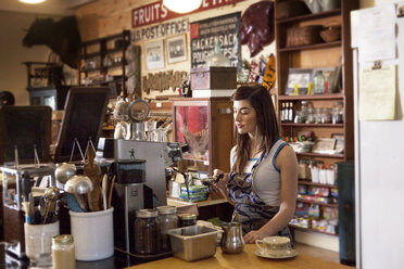 Female owner working at coffee shop - CAVF09583