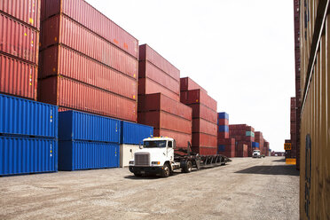 Semi-truck by cargo containers at commercial dock - CAVF09766