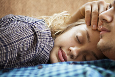 Close-up of couple sleeping at home - CAVF10045