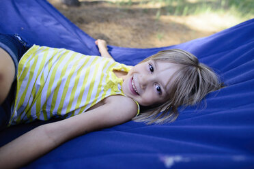 High angle portrait of happy girl relaxing in hammock - CAVF10369