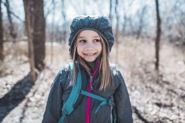 Girl looking away while standing in forest - CAVF10505