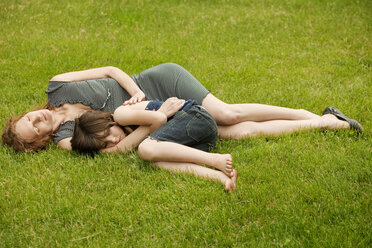 Mother and daughter sleeping at backyard - CAVF10706