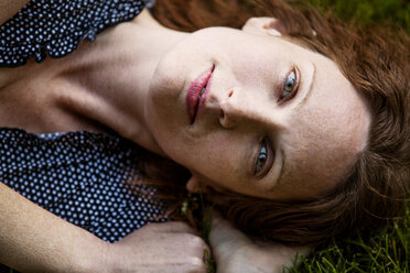 Portrait of woman lying on field - CAVF10737