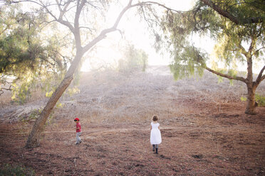 Siblings walking on field - CAVF11012