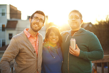 Portrait of happy friends standing against sky during sunset - CAVF11184