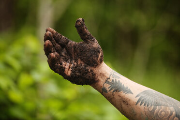 Cropped image of muddy hand - CAVF11417