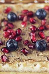 Close-up of biscuit garnish with pomegranate seeds and blueberries - CAVF11525