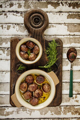 Overhead view of meatballs in bowls on cutting board - CAVF11577